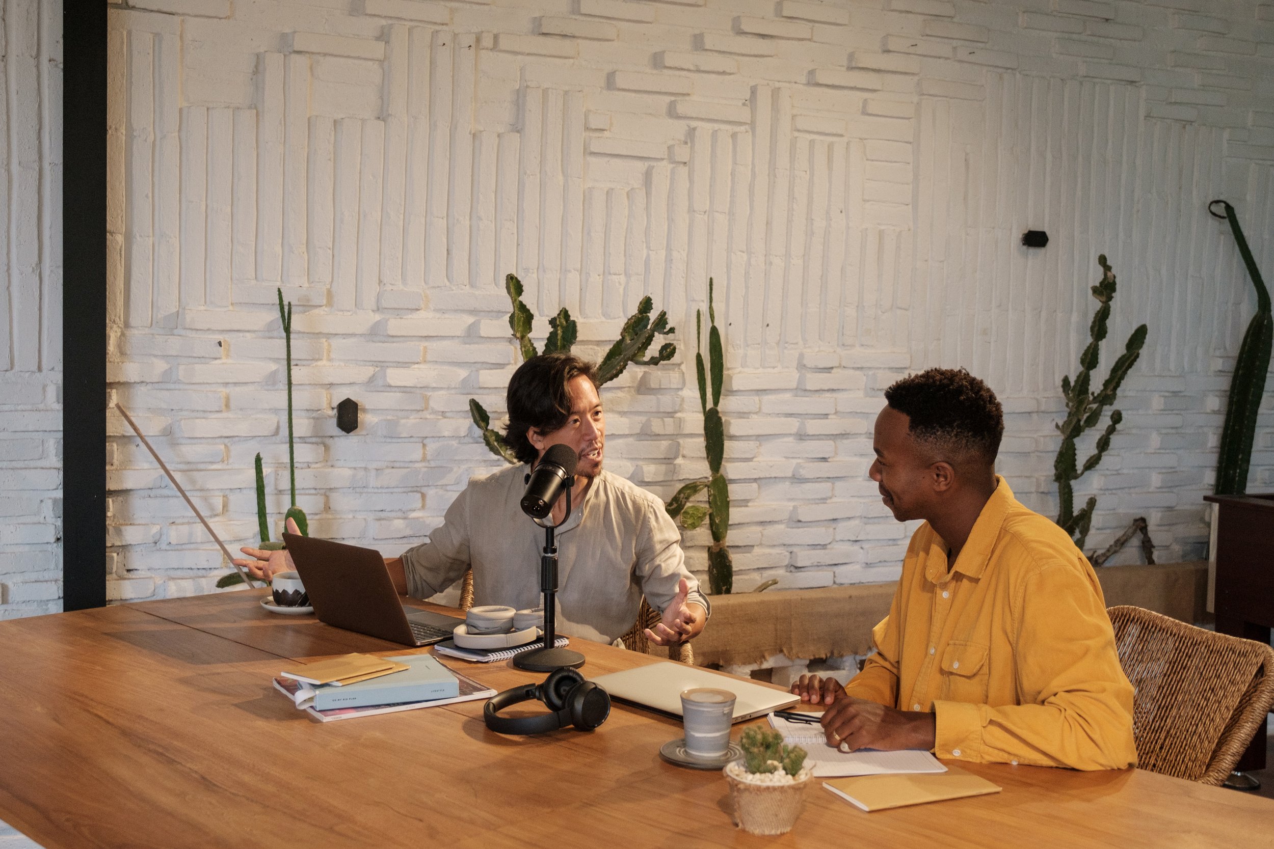 Two Male Podcasters Talking to Each Other Outdoors